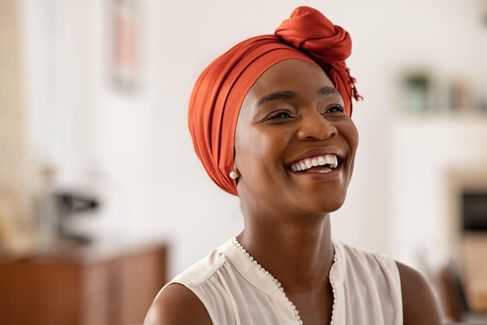 Smiling middle aged woman with orange headscarf