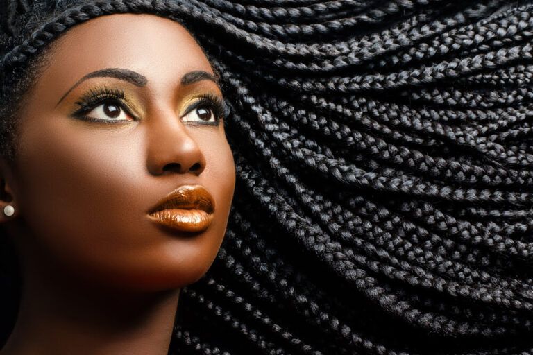 beautiful woman showing long black braided hairstyle