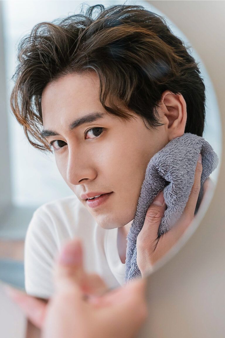 beautiful boy with perfect glow touching skin