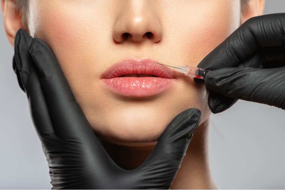 woman getting botox cosmetic injection in the lips