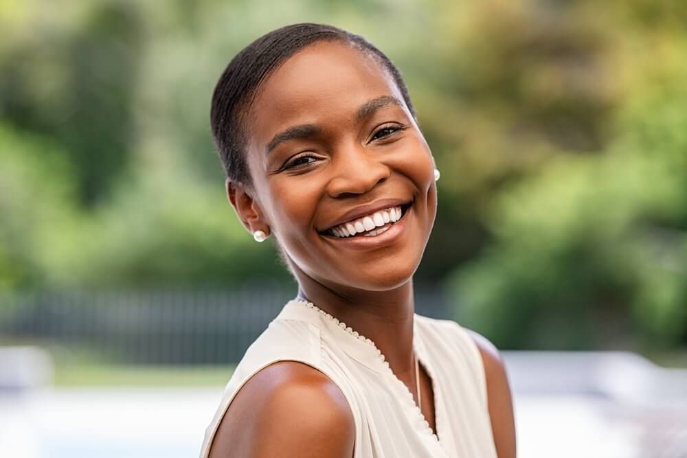 Smiling middle aged African woman looking at camera