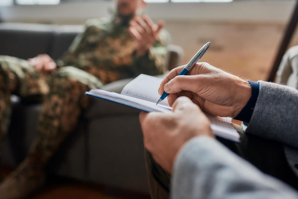 Close up of hands of psychologist making notes,