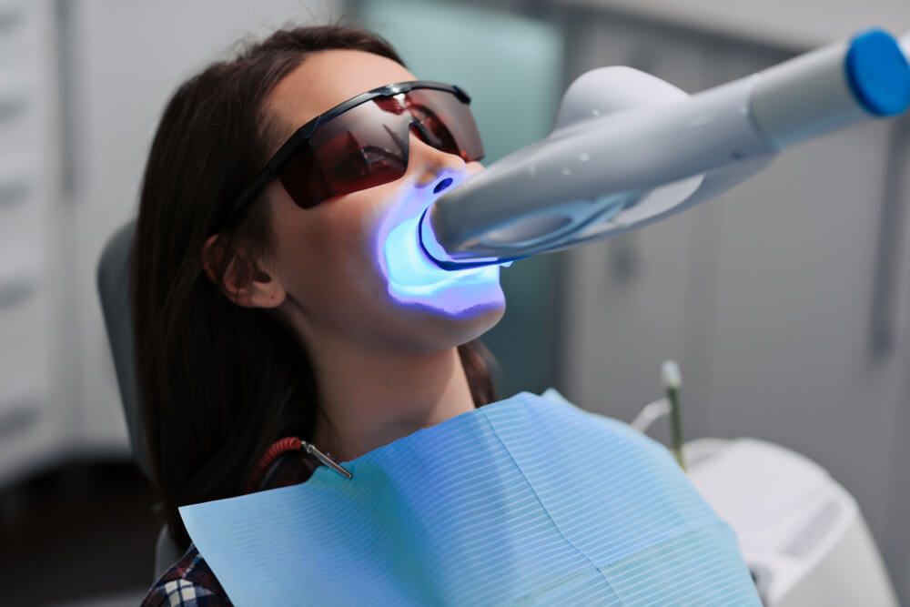 Teeth whitening procedure with ultraviolet light UV lamp
