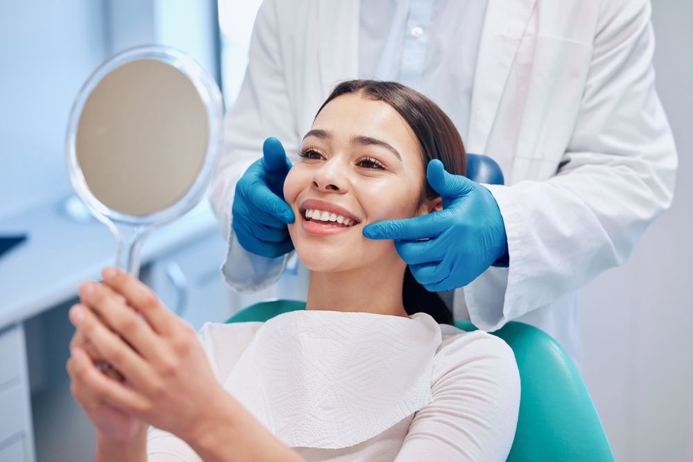 Woman smiling after receiving a Dental Cleaning and Consultation 