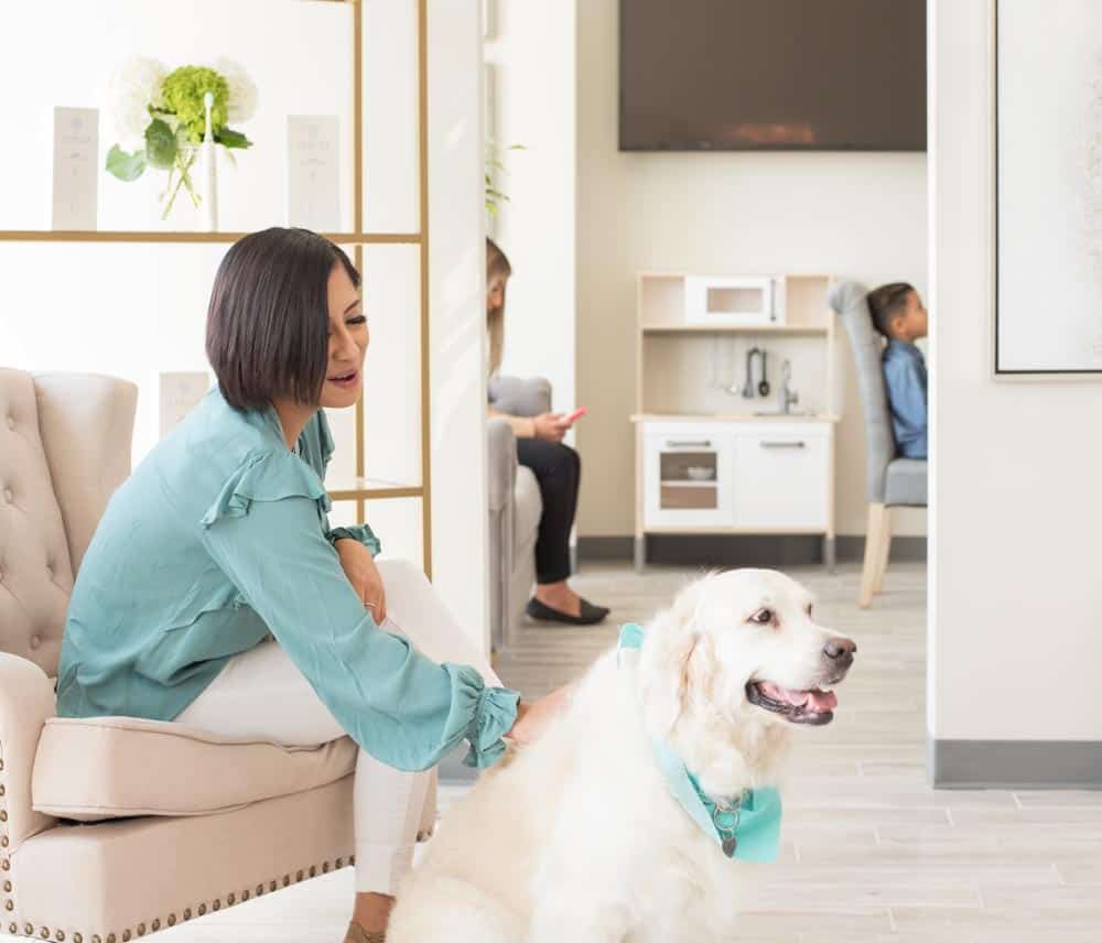 Girl visiting dental office with pet dog