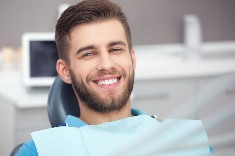 Young boy smiling sitting on dental chair