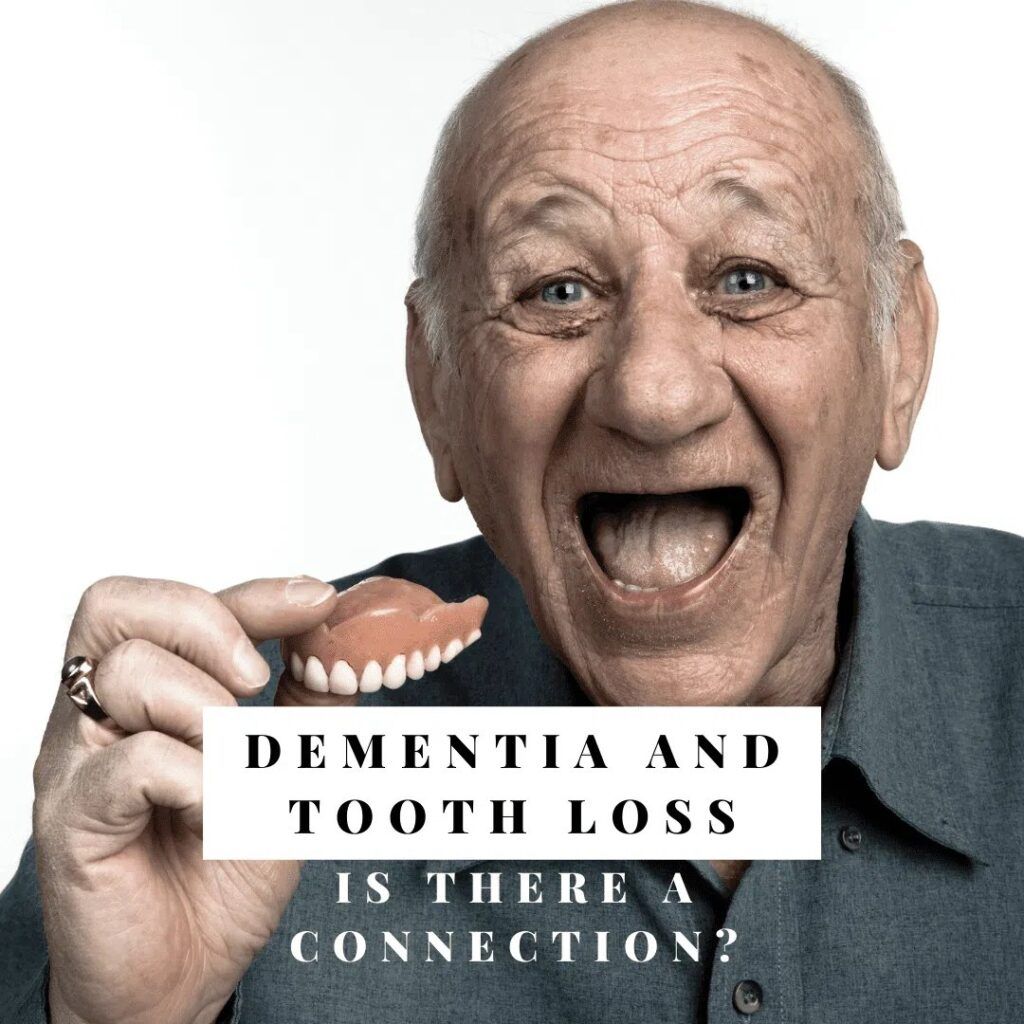 Old man holding denture and smiling