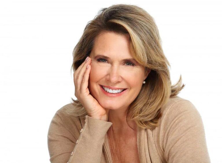 Aged woman smiling and looking at camera