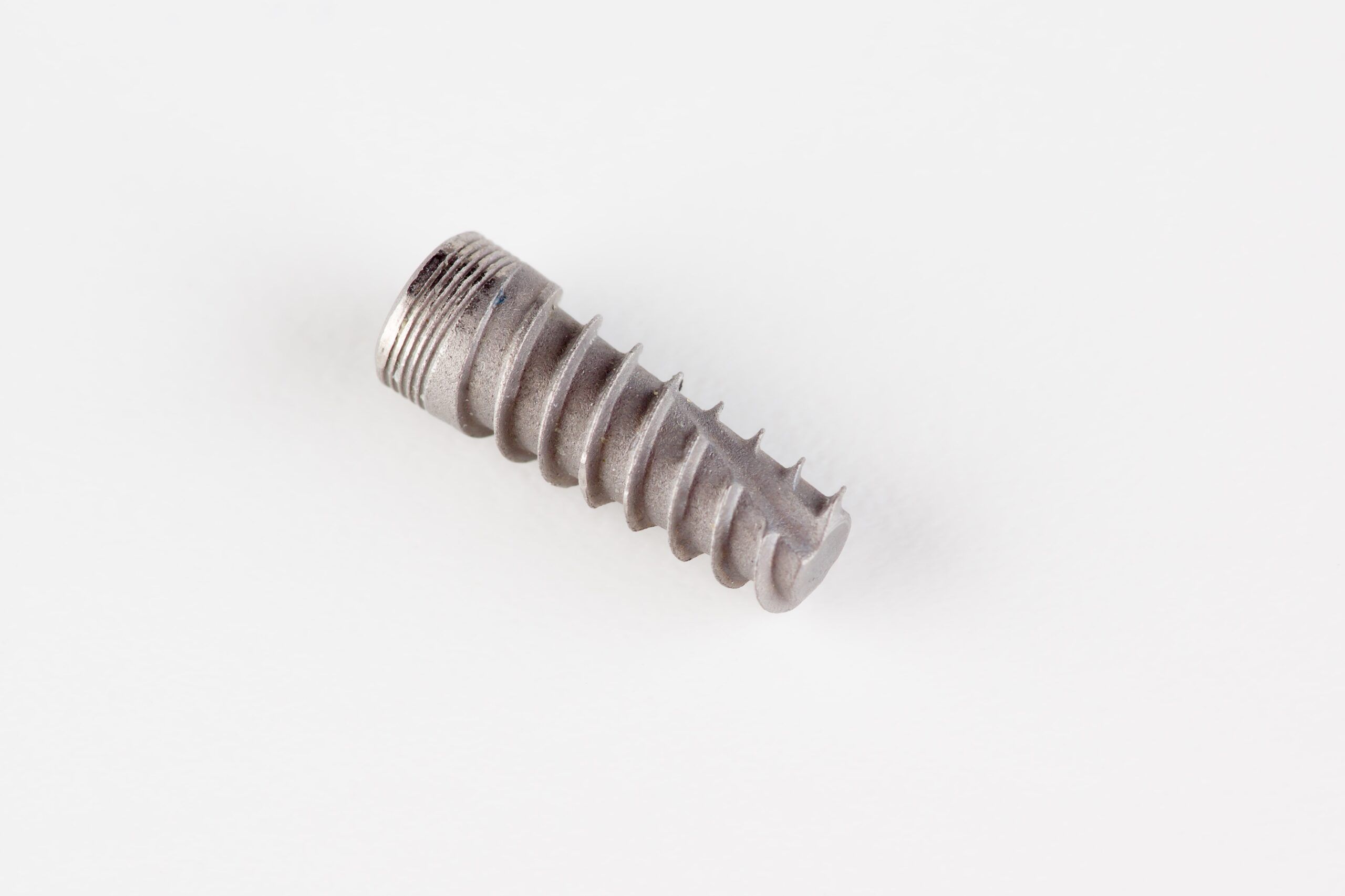 dental titanium implant with locking elements isolated on white background