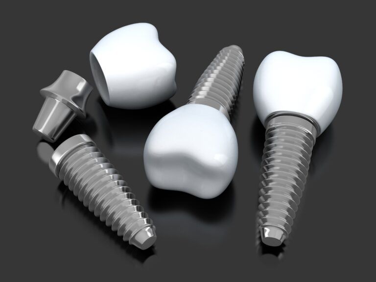 scattered dental implants on a black background