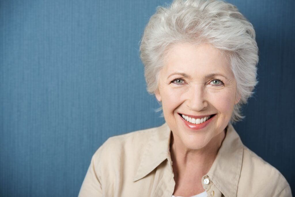 senior woman smiling on a blue background