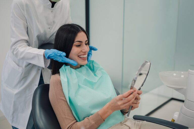 smiling while showing a patient her perfect teeth in the mirror after a successful dental treatment at the clinic, radiating satisfaction and confidence