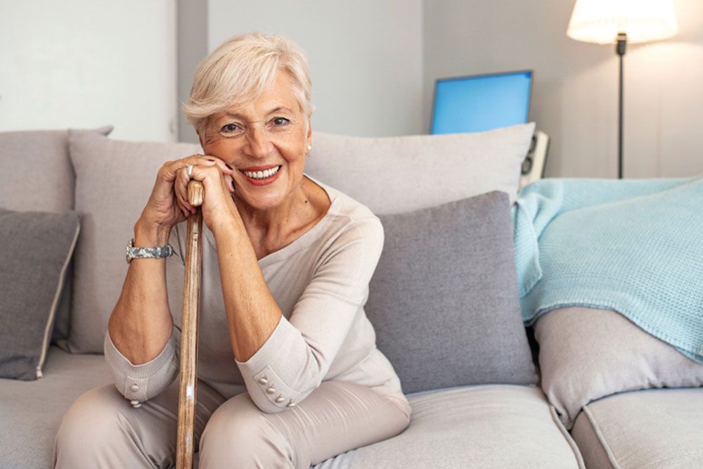 Smiling grandmother sitting on couch