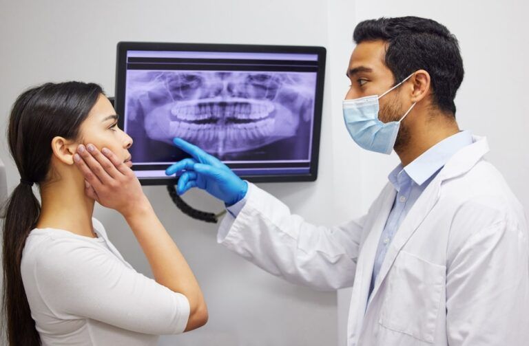 Dentist, communication and x ray of teeth on screen for patient education, dental diagnosis