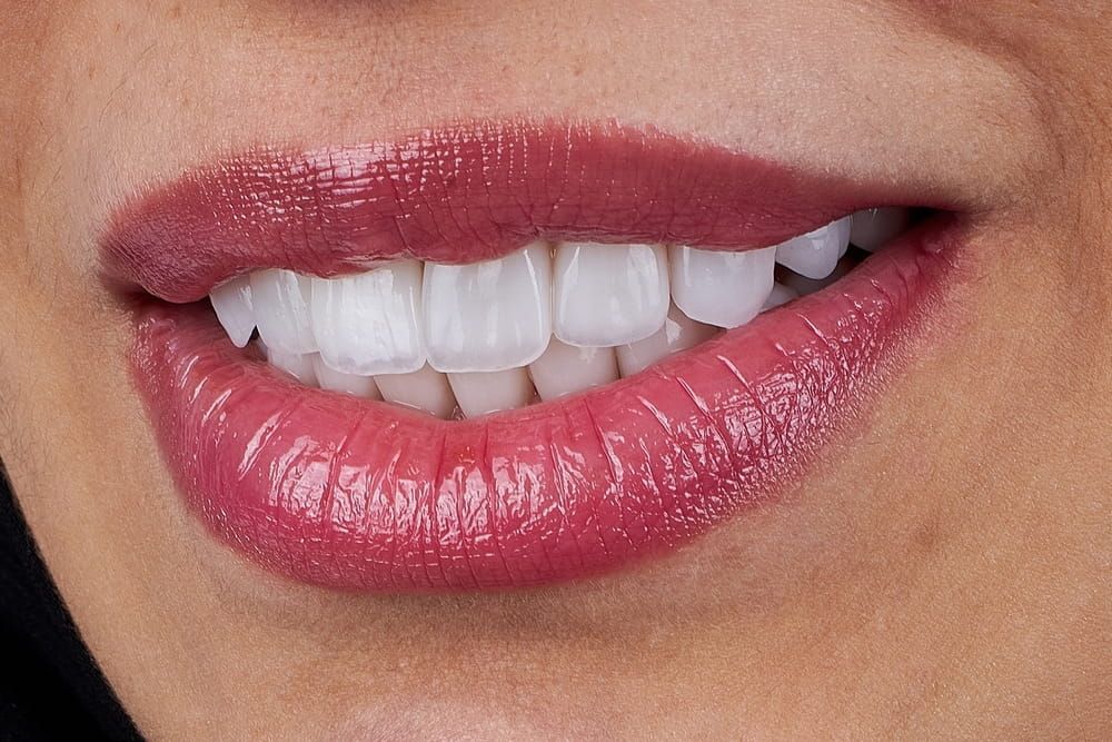 Procedures include teeth whitening, veneers, bonding, and implants