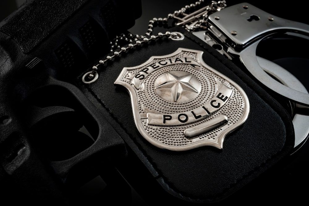 A police badge and a pair of handcuffs
