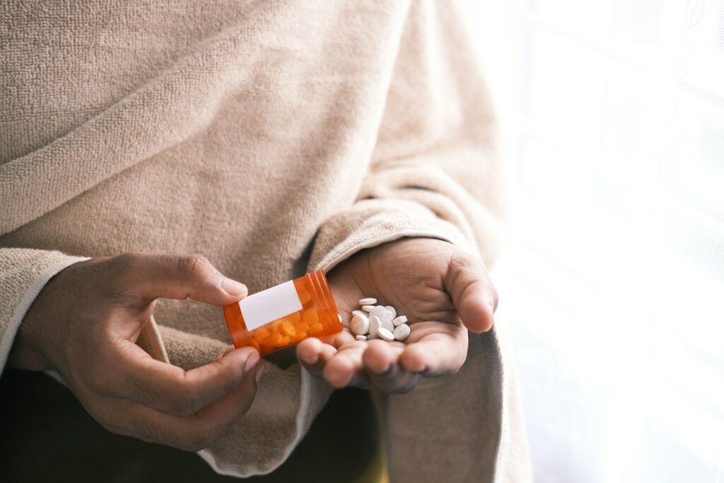 A person pouring pills