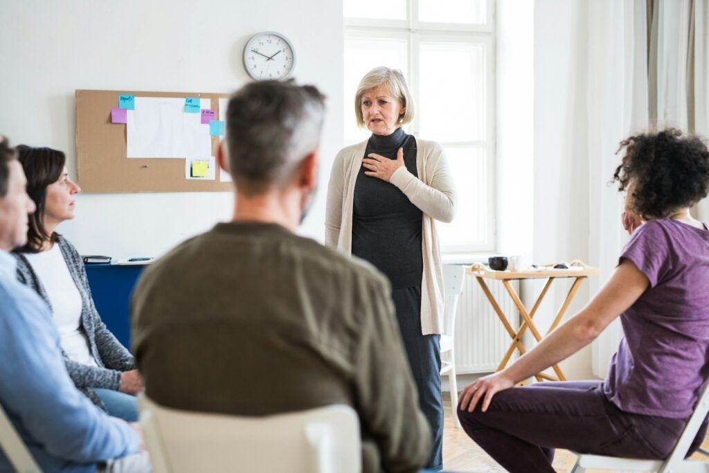 A person talking to a group of people