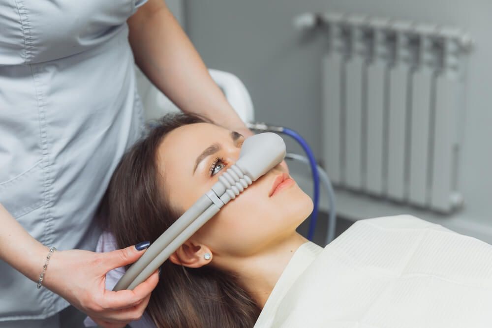 dentist puts inhalation sedative mask on his patient.