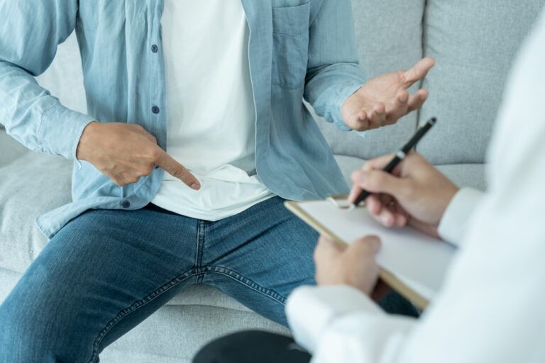 Man hold hand in front of private parts feeling discomfort and consult doctor
