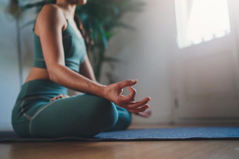 Closeup of young woman practicing yoga in the morning