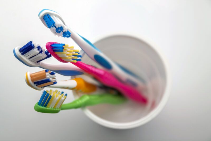 Close up shot of set of multicolored toothbrushes