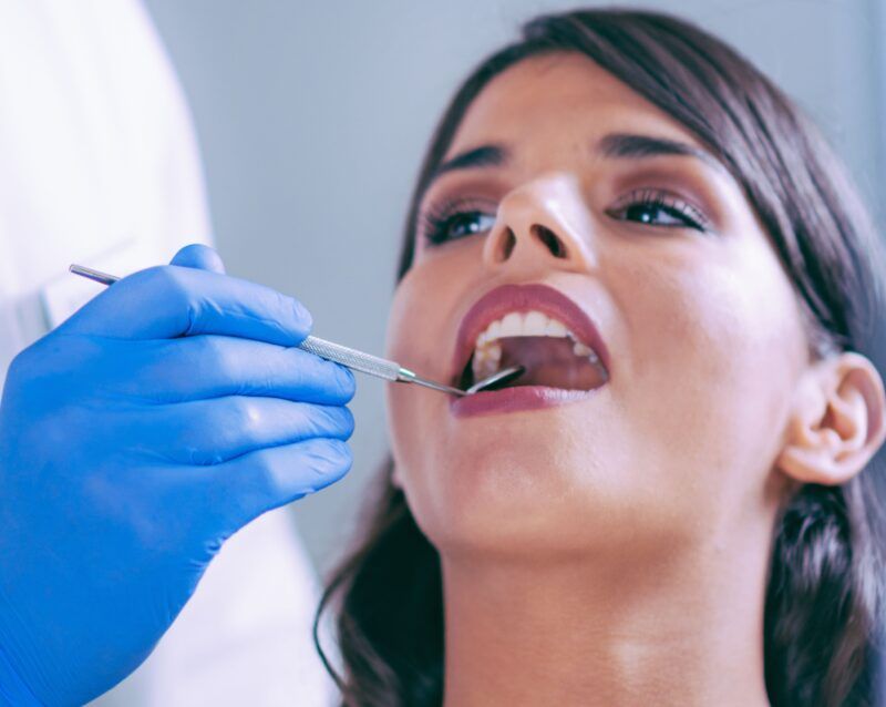 Woman at dentist with dental mirror in mouth