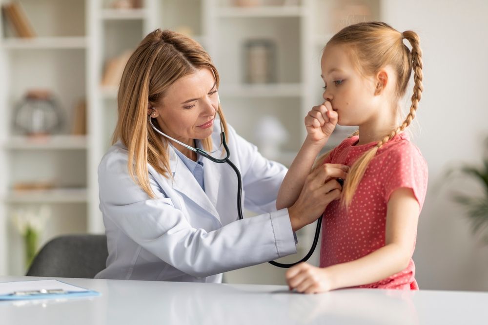 Pediatrician Lady With Stethoscope Listening Lungs Of Coughing Little Girl