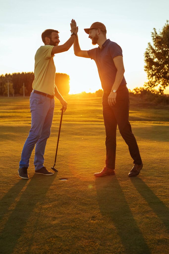 Shot of two golfers congratulating each other with a high five
