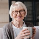 relaxed senior old elderly woman grandmother drinking hot beverage